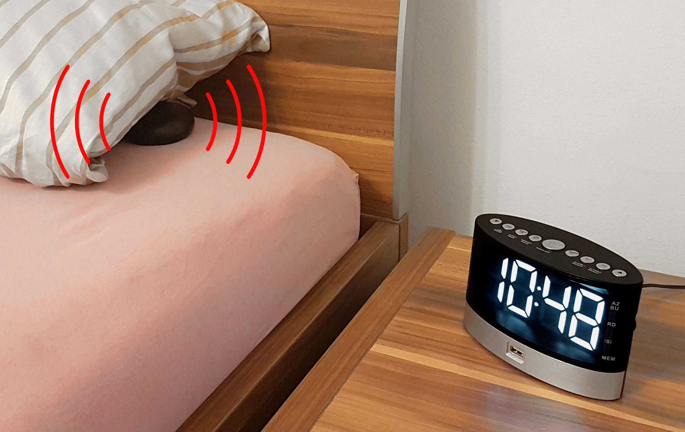 FM clock radio for aurally handicapped people with wireless wake-up vibrating pad